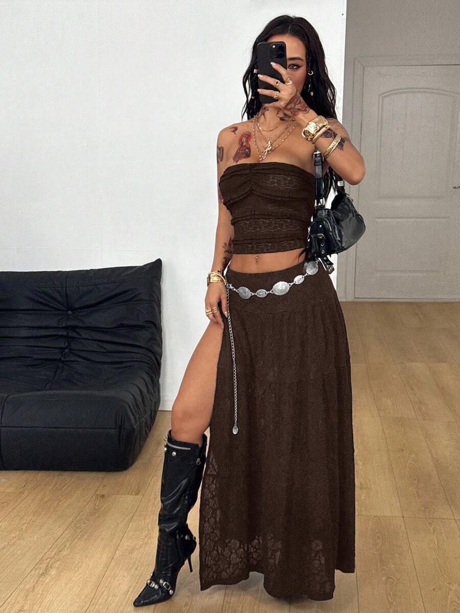 Women's black low waist split thigh long skirt featuring semi-sheer textured fabric and a flared skinny fit.