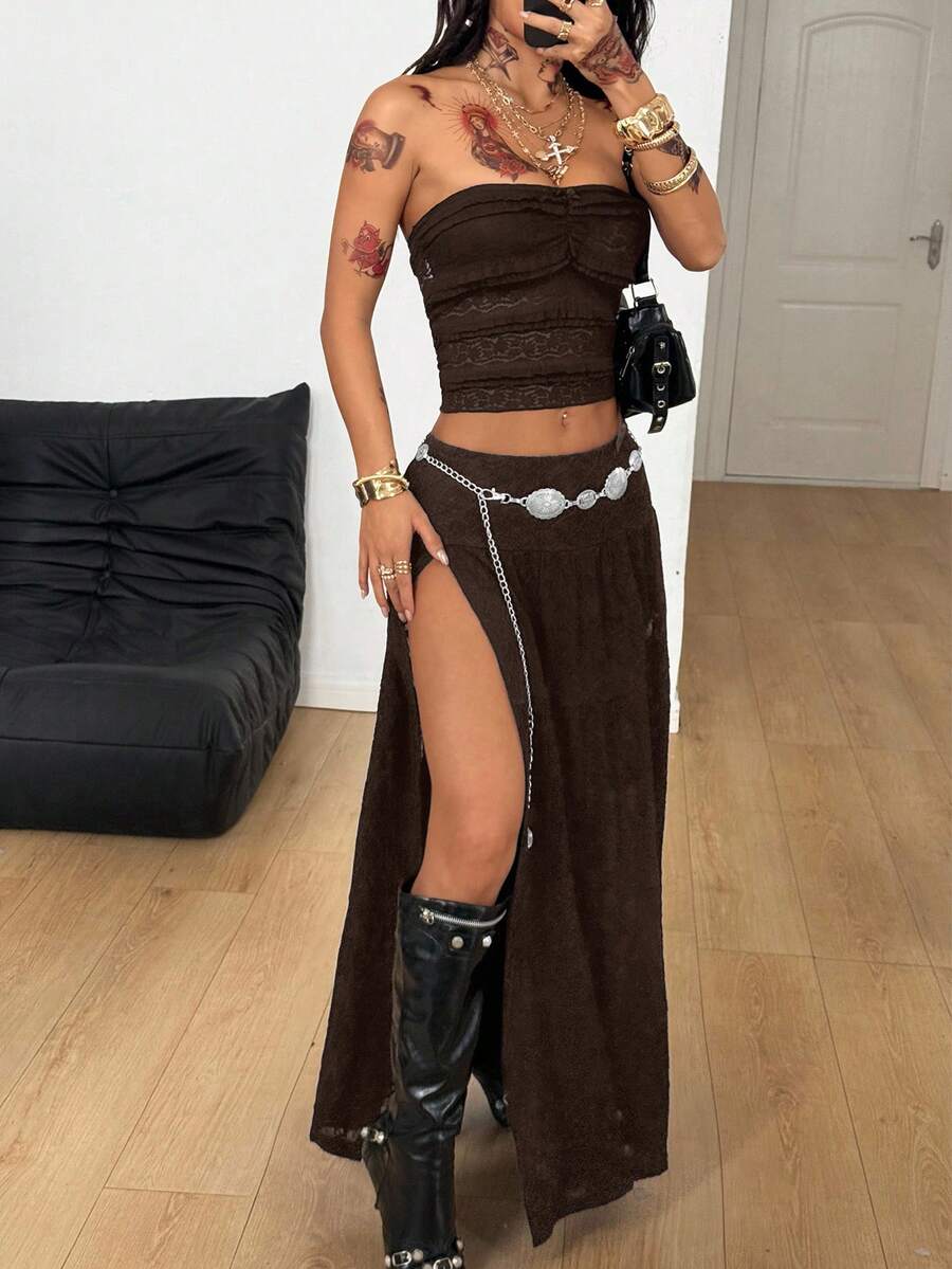 Women's black low waist split thigh long skirt featuring semi-sheer textured fabric and a flared skinny fit.