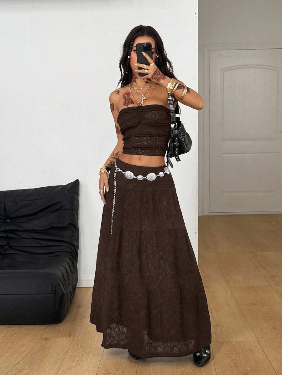 Women's black low waist split thigh long skirt featuring semi-sheer textured fabric and a flared skinny fit.