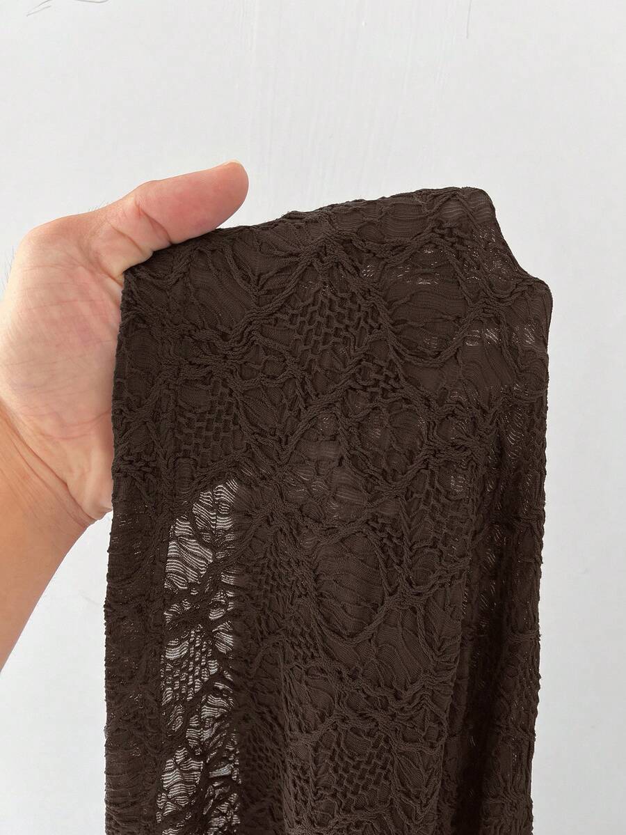 Women's black low waist split thigh long skirt featuring semi-sheer textured fabric and a flared skinny fit.