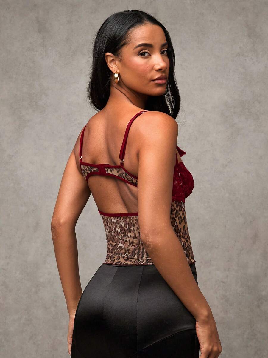 Women's black contrast lace camisole with spaghetti straps, cup detail, semi-sheer finish, and slim fit for going out or date night.