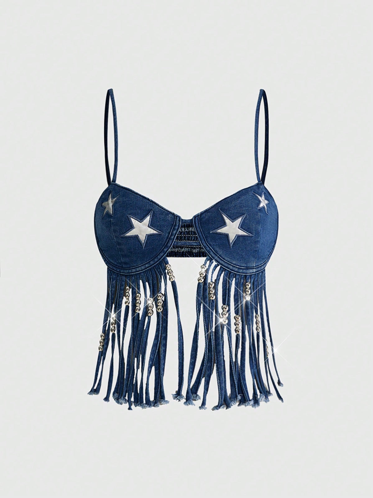 Blue denim camisole top for women featuring star patch detailing, fringe tassel asymmetrical hem, and spaghetti straps.