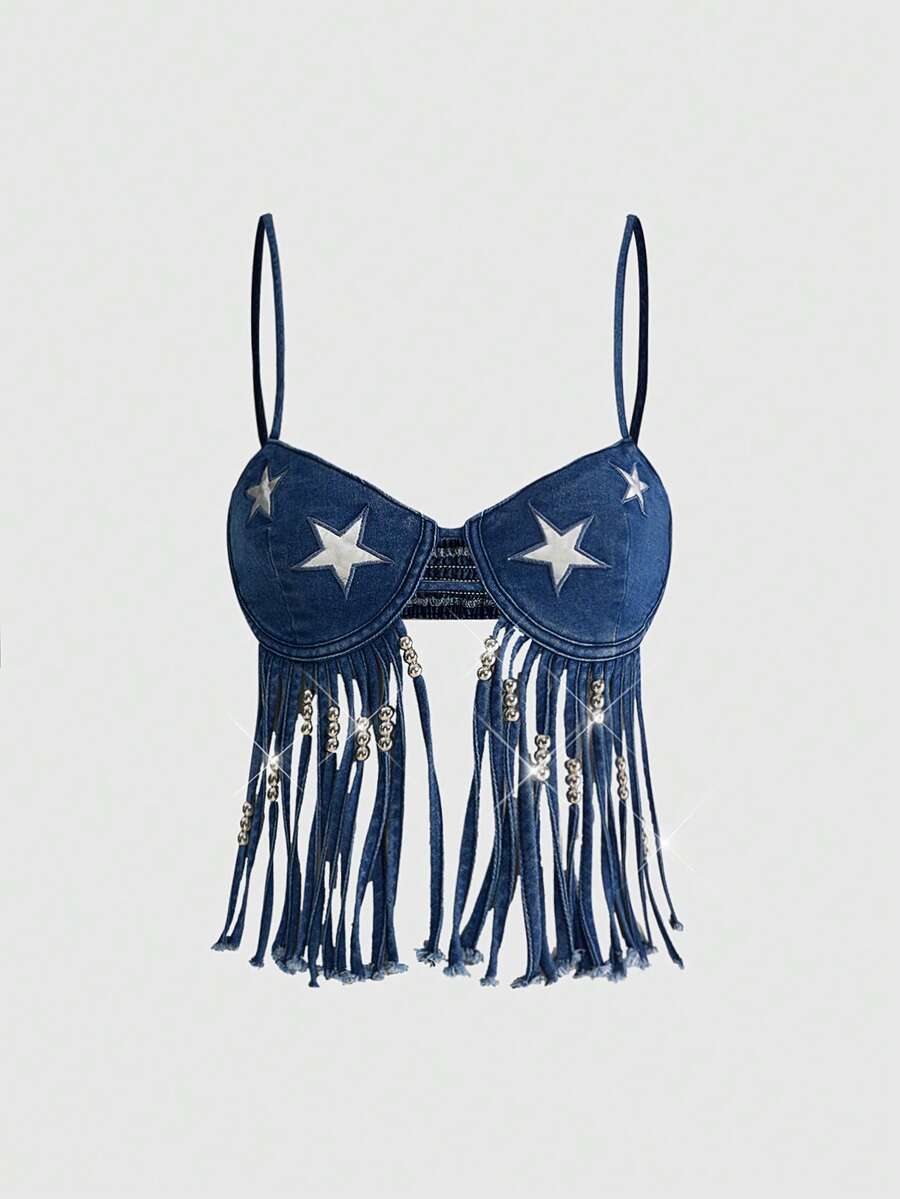 Blue denim camisole top for women featuring star patch detailing, fringe tassel asymmetrical hem, and spaghetti straps.