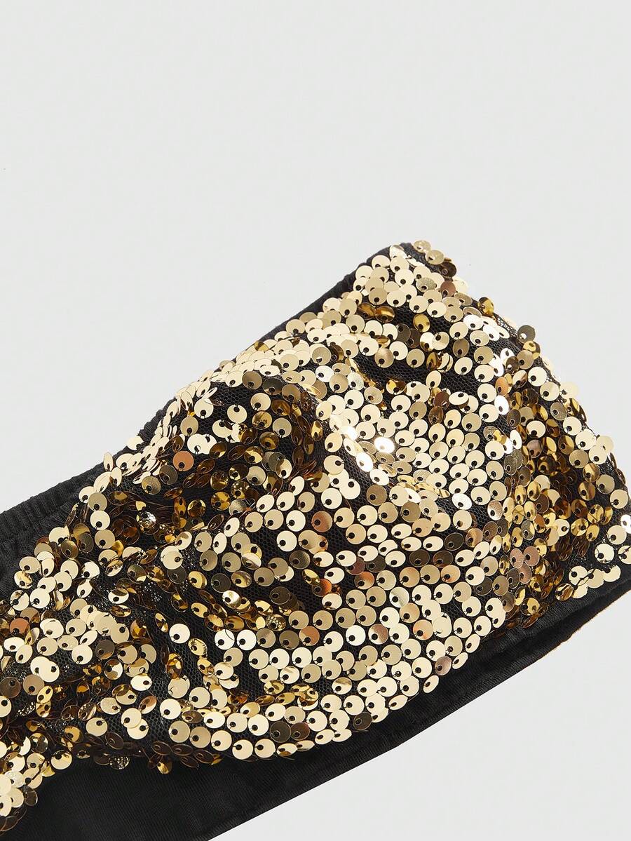 Women's black sequin halter tank top featuring a draped cowl neck and backless design