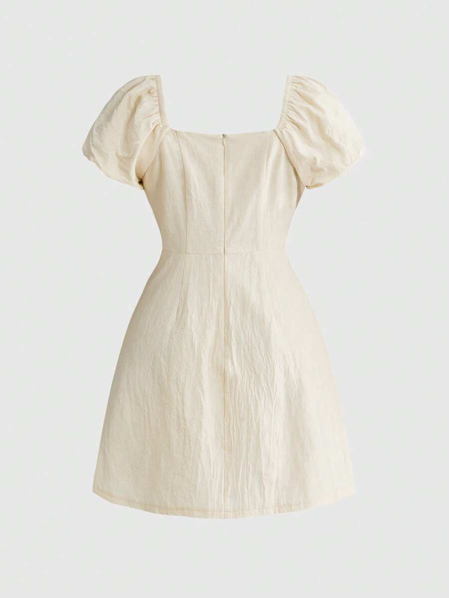 White Goth mini skater dress for women featuring dark skull graphic print, square neckline, short puff sleeves, and lace-up detail.