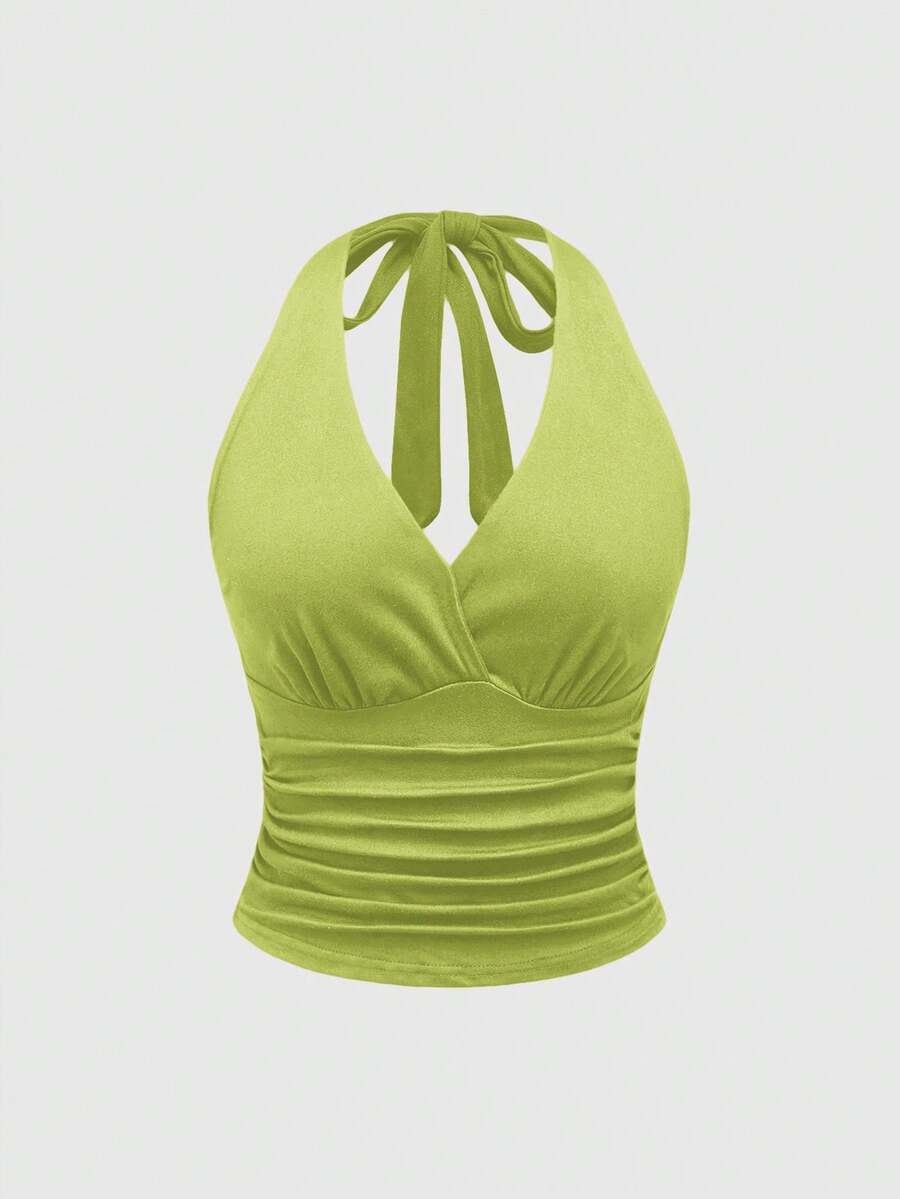 Women's halter crop tank top featuring a backless silhouette and ruched detailing in a slim fit design.