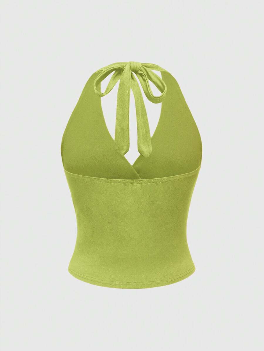 Women's halter crop tank top featuring a backless silhouette and ruched detailing in a slim fit design.