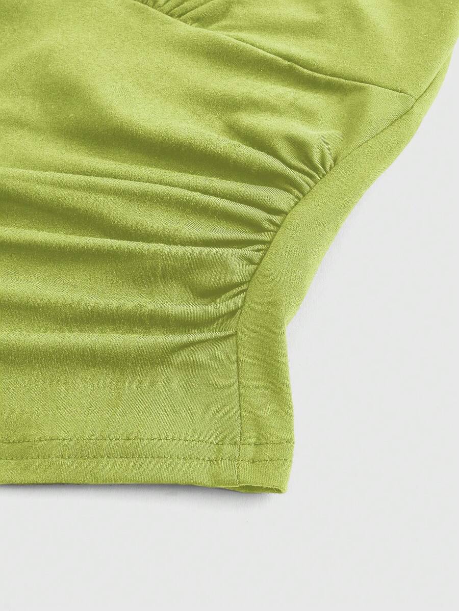 Women's halter crop tank top featuring a backless silhouette and ruched detailing in a slim fit design.