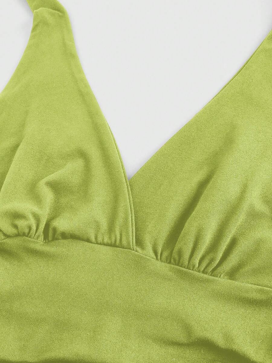 Women's halter crop tank top featuring a backless silhouette and ruched detailing in a slim fit design.
