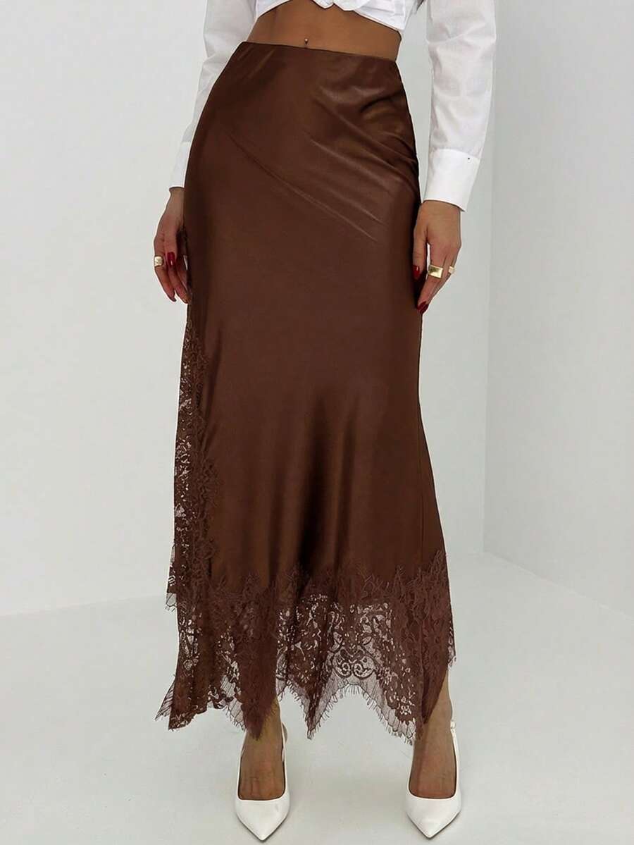 Women's elegant black lace patchwork mermaid maxi skirt featuring asymmetrical contrast lace design and low waist fit.