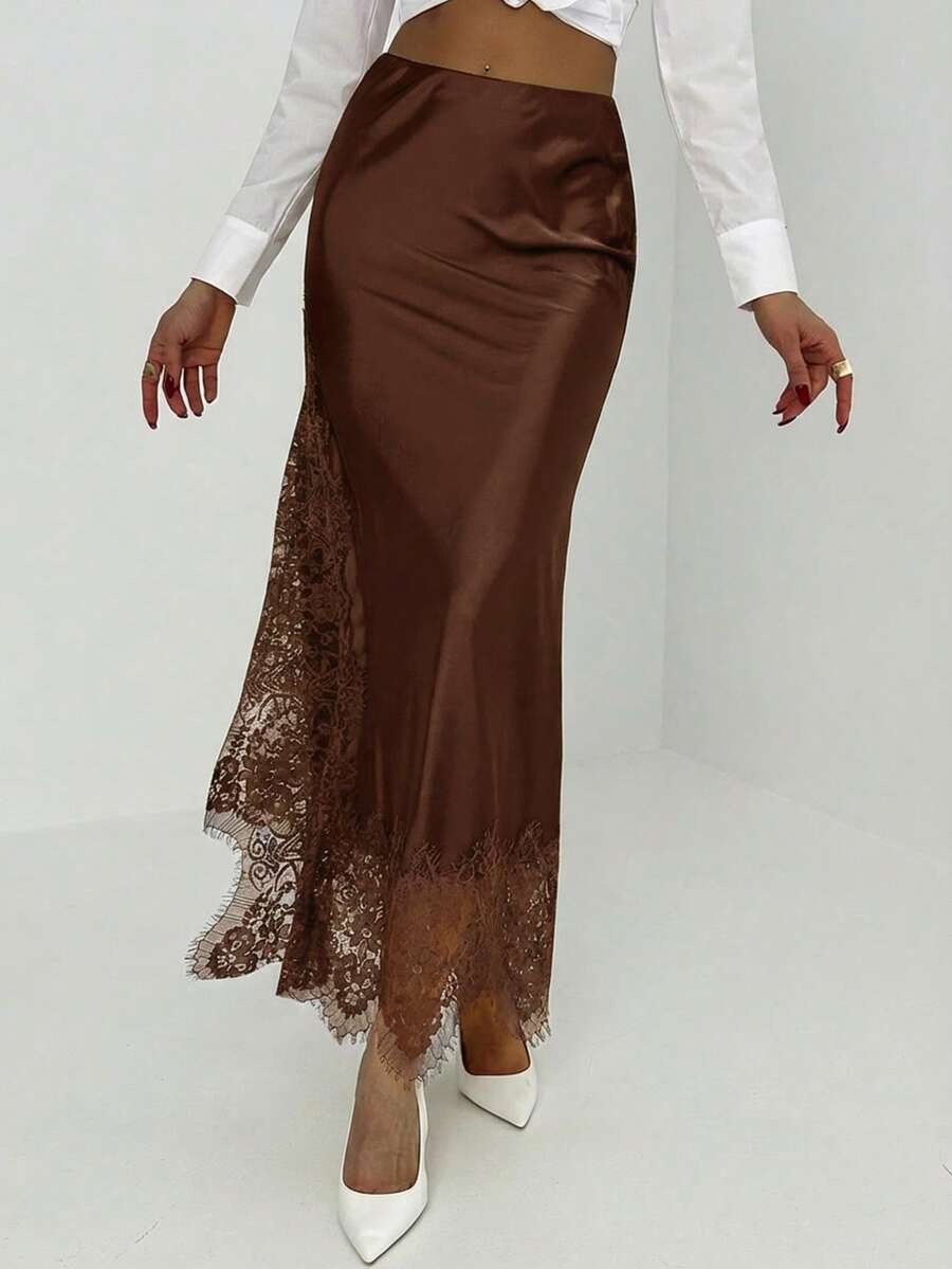 Women's elegant black lace patchwork mermaid maxi skirt featuring asymmetrical contrast lace design and low waist fit.