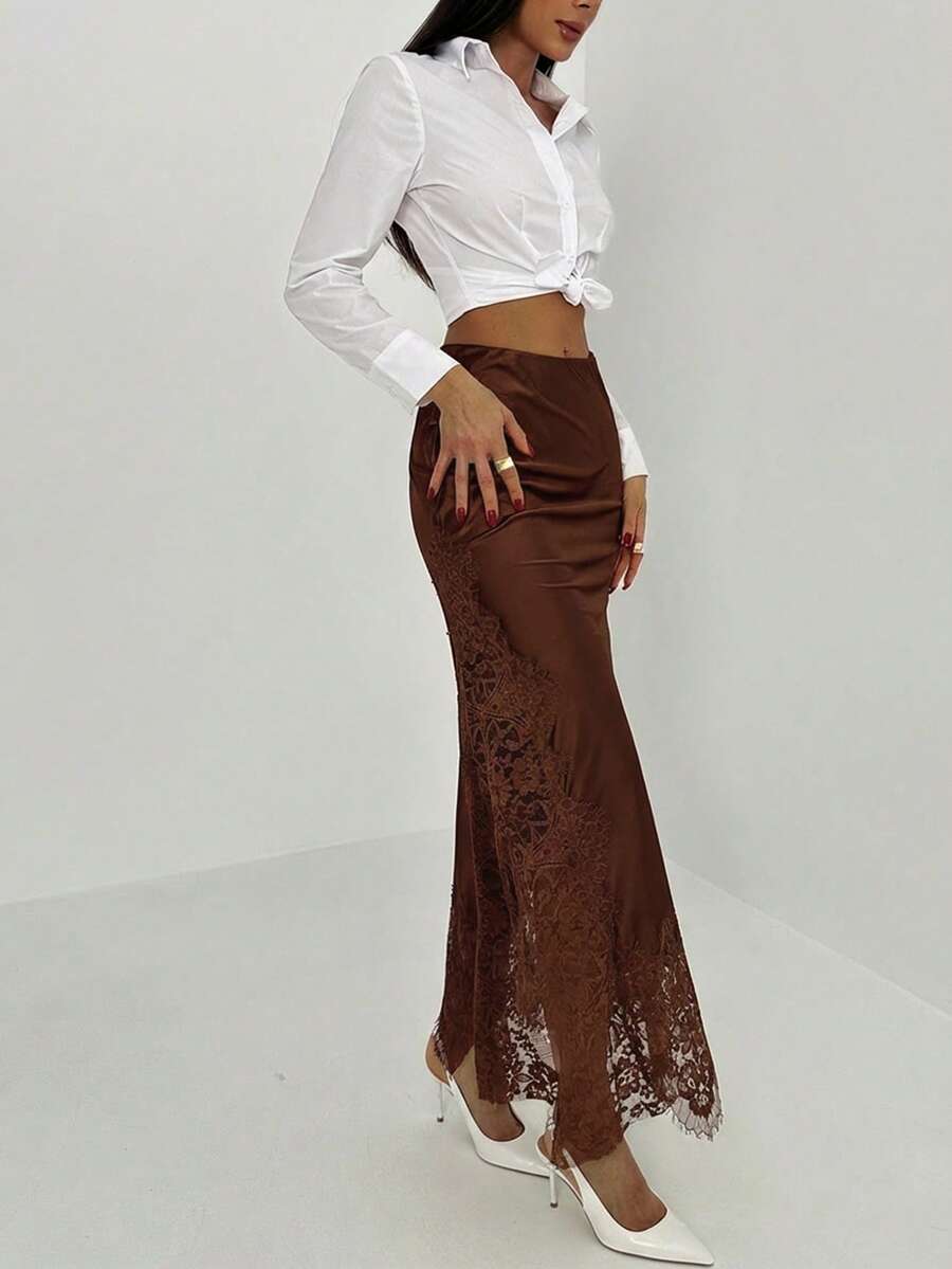 Women's elegant black lace patchwork mermaid maxi skirt featuring asymmetrical contrast lace design and low waist fit.