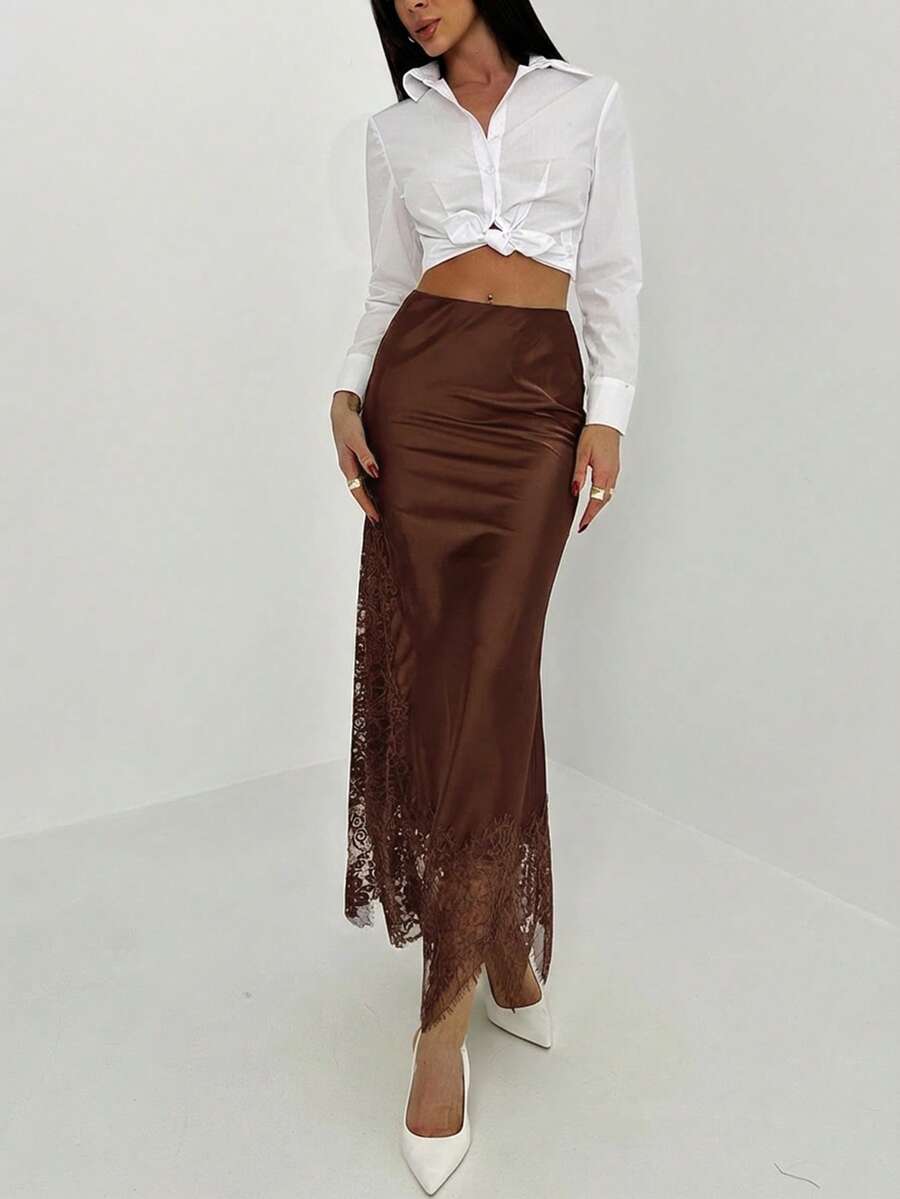 Women's elegant black lace patchwork mermaid maxi skirt featuring asymmetrical contrast lace design and low waist fit.