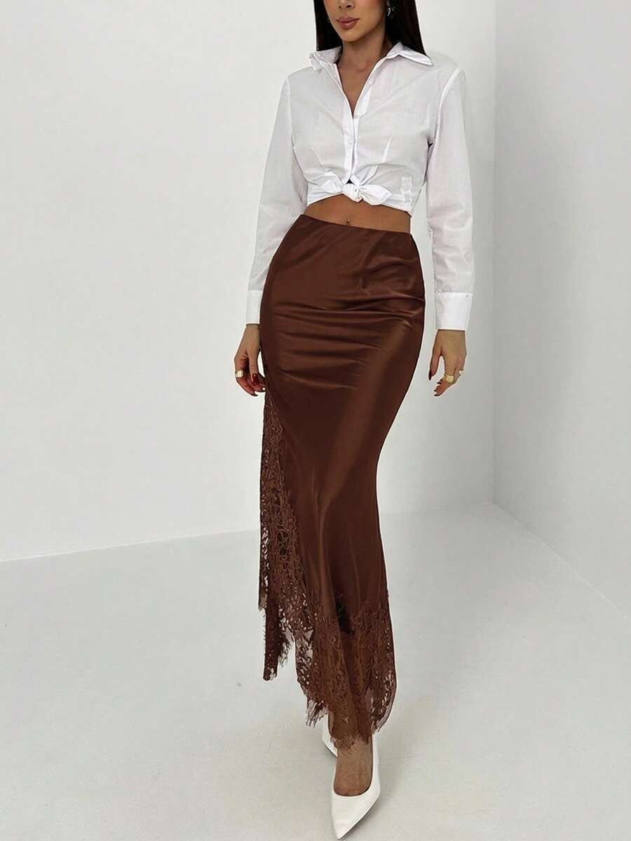 Women's elegant black lace patchwork mermaid maxi skirt featuring asymmetrical contrast lace design and low waist fit.
