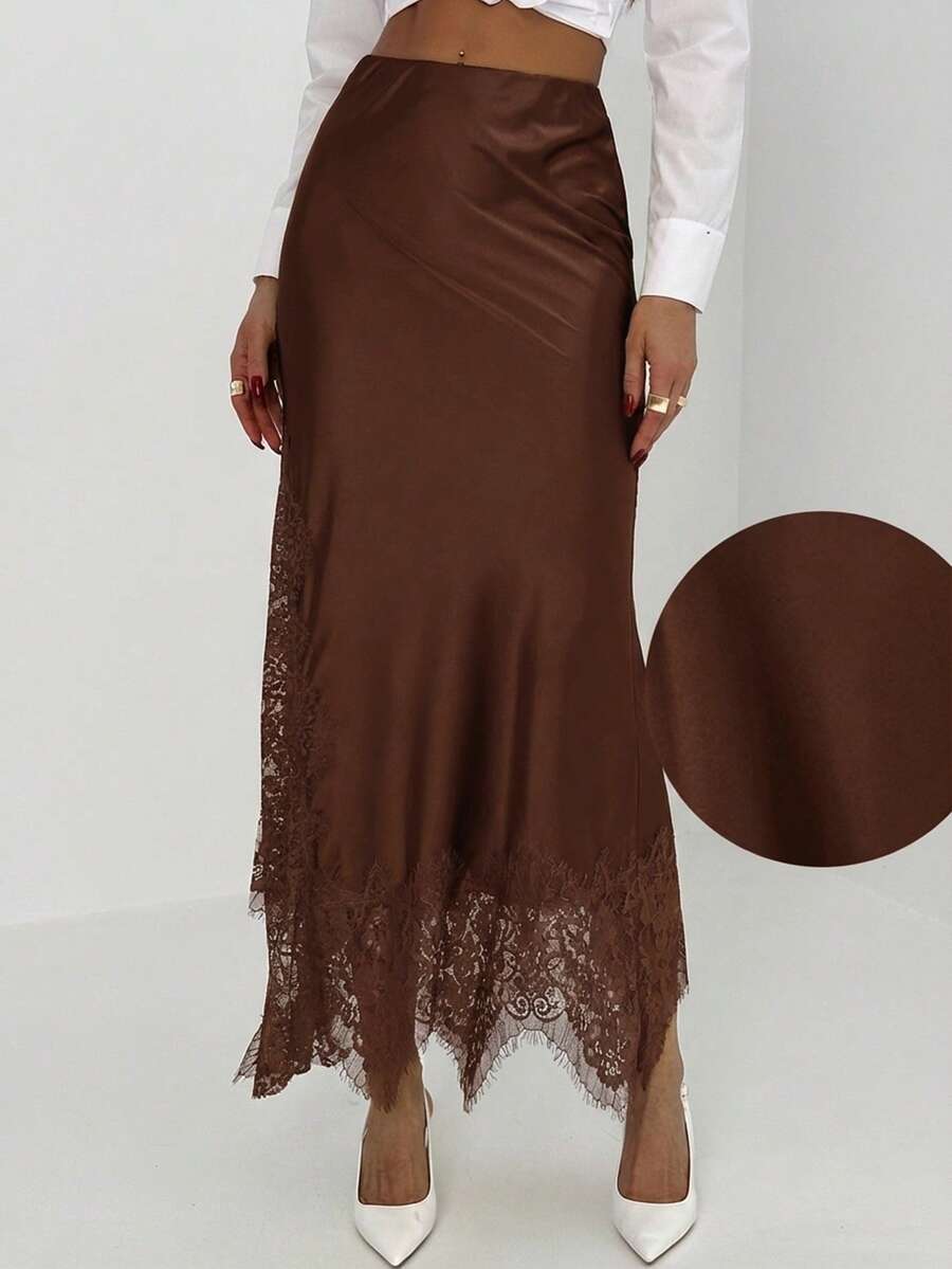 Women's elegant black lace patchwork mermaid maxi skirt featuring asymmetrical contrast lace design and low waist fit.