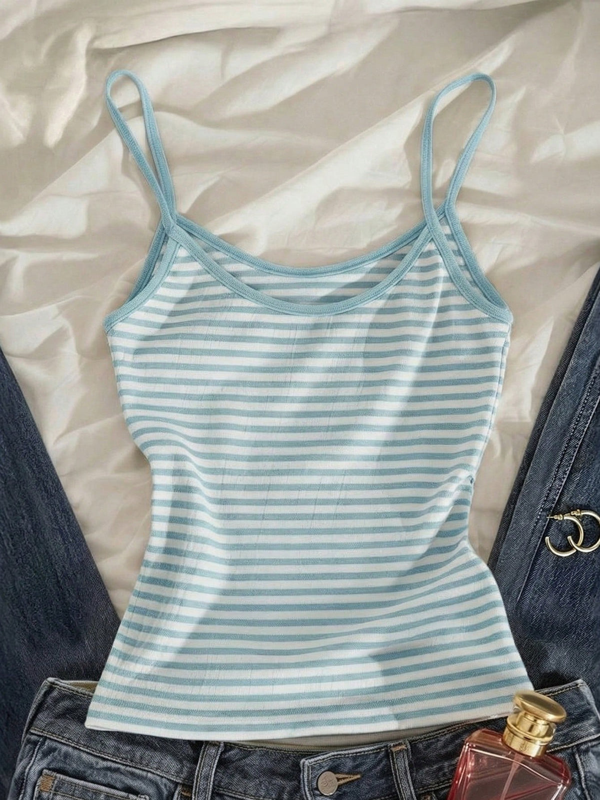 Women's pink striped crop camisole featuring criss cross spaghetti straps and slim fit design.