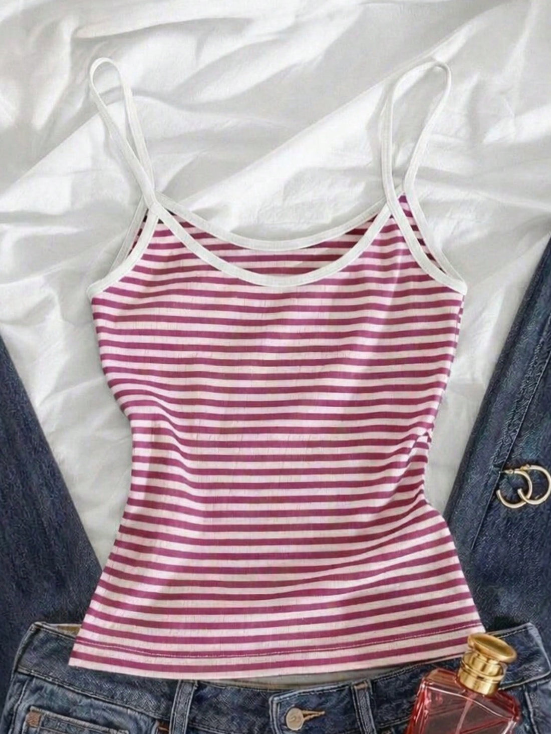 Women's pink striped crop camisole featuring criss cross spaghetti straps and slim fit design.
