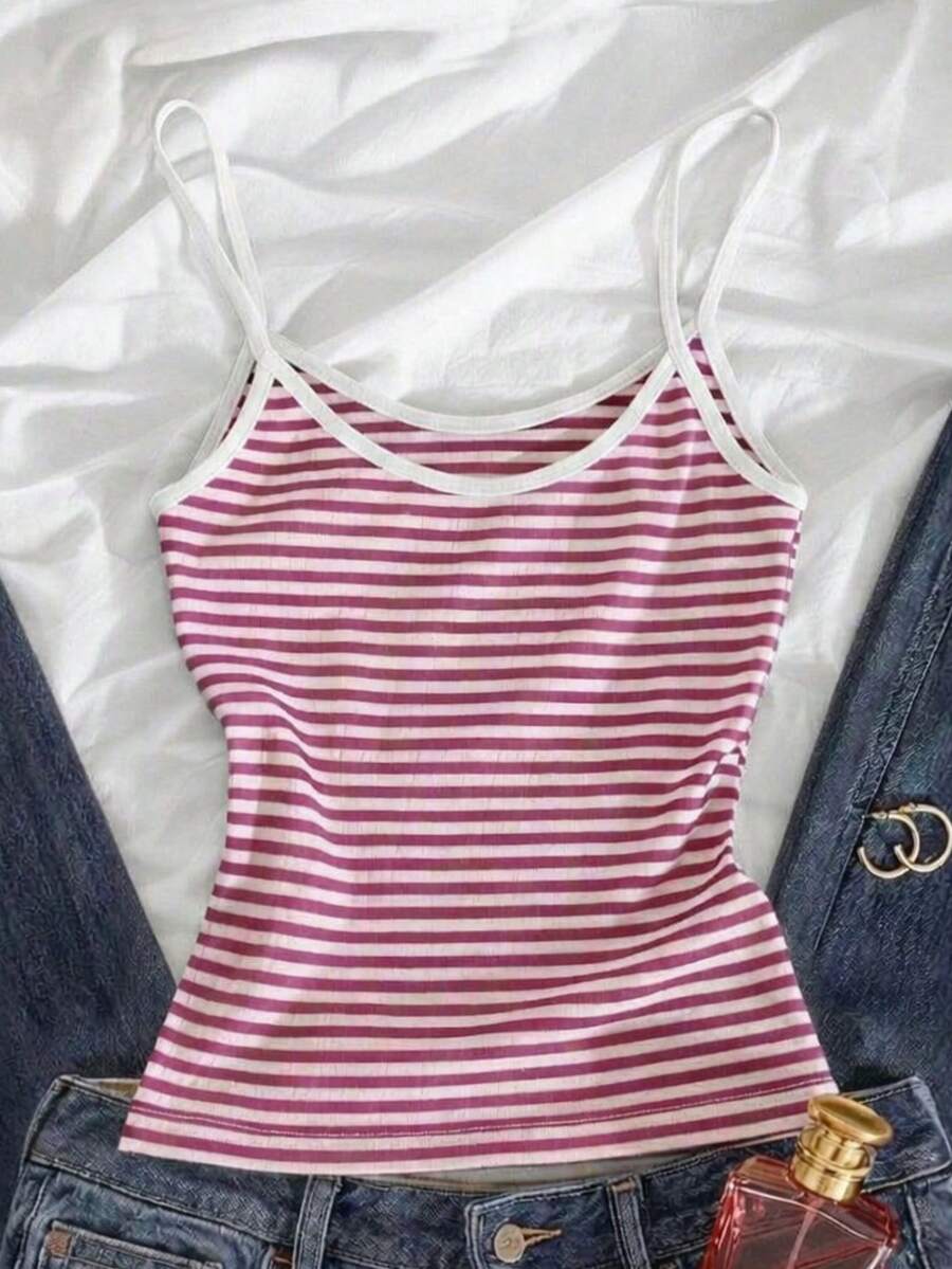 Women's pink striped crop camisole featuring criss cross spaghetti straps and slim fit design.