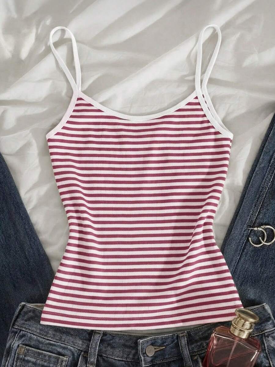 Women's pink striped crop camisole featuring criss cross spaghetti straps and slim fit design.