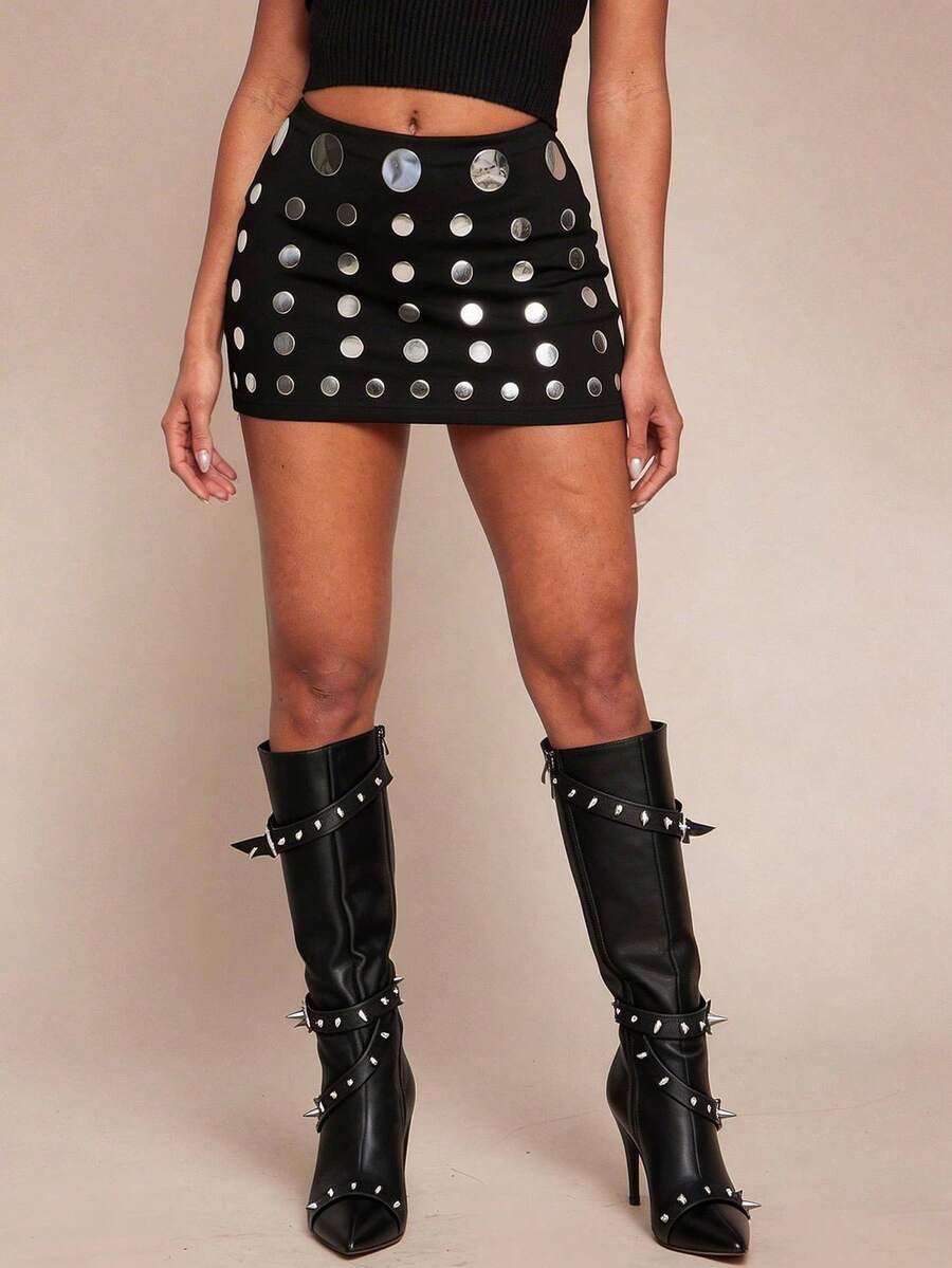 Women's black bodycon mini skort featuring a low waist, pleated side split hem, zipper closure, and built-in shorts.