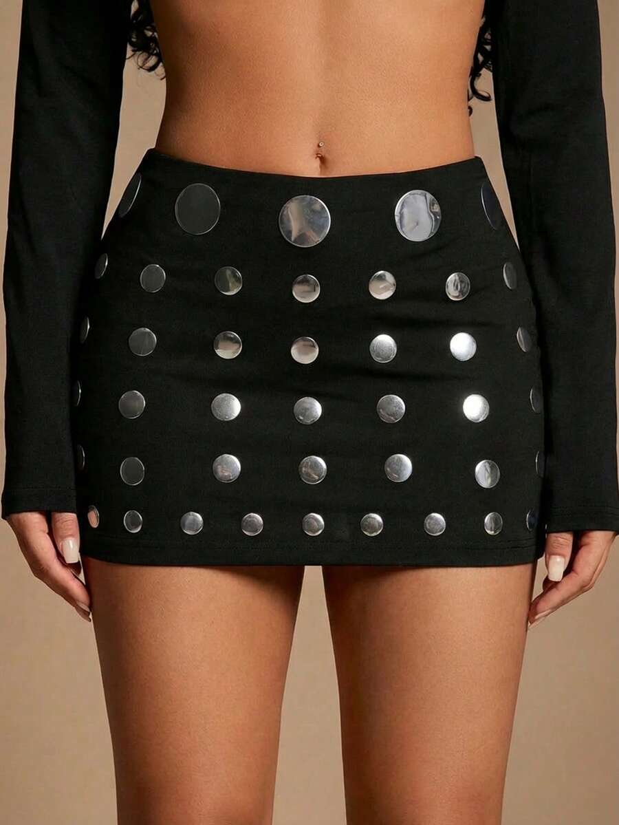 Women's black bodycon mini skort featuring a low waist, pleated side split hem, zipper closure, and built-in shorts.