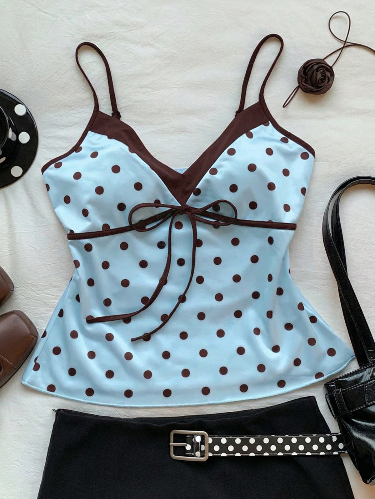 Black and white polka dot tie strap camisole top for women with thin spaghetti straps and slim fit.