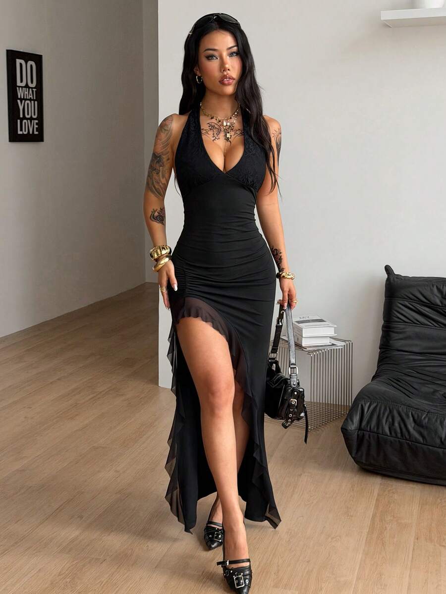 Women's black halter sleeveless bodycon maxi dress with a split thigh asymmetrical hem in knitted fabric.