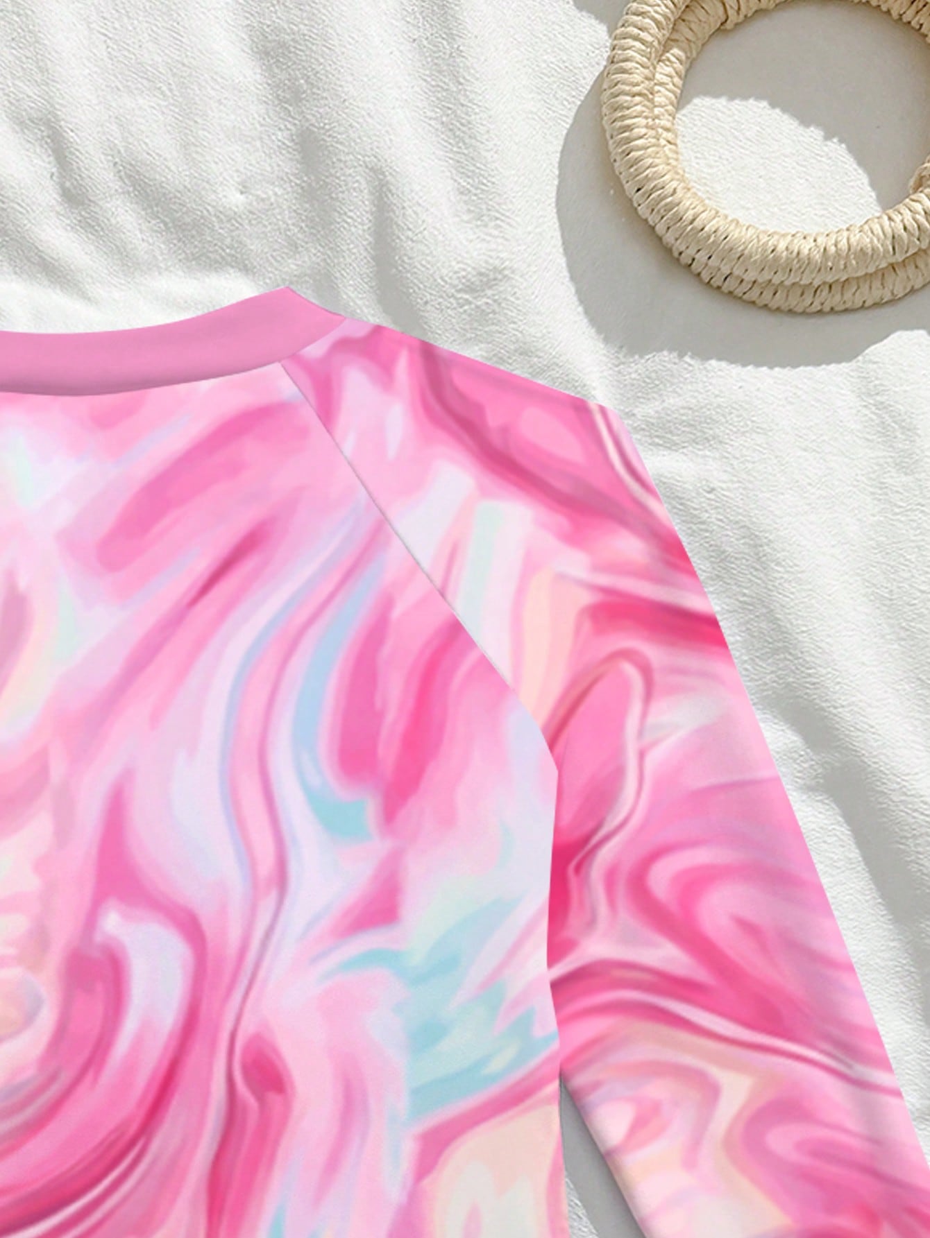 Tween girls one-piece rash guard swimsuit with long sleeves, high neck, front zipper, and ocean shell graphic print in a fitted style for beach, swimming, and vacation wear.