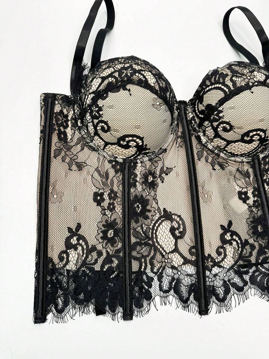Black women's shaping cami with contrast lace, spaghetti straps, asymmetrical hem, lined body, and slim fit for casual and night-out styling.
