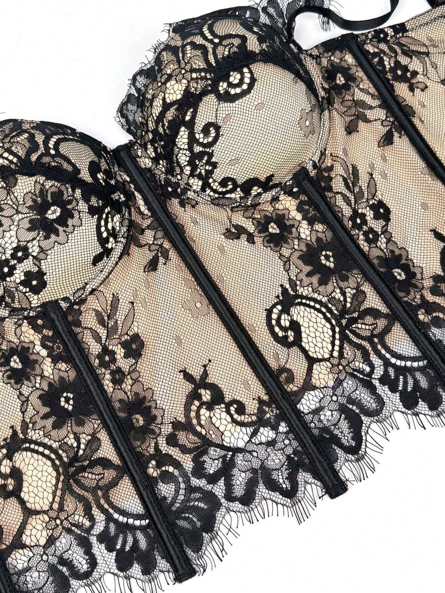 Black women's shaping cami with contrast lace, spaghetti straps, asymmetrical hem, lined body, and slim fit for casual and night-out styling.