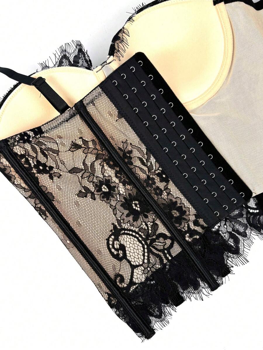 Black women's shaping cami with contrast lace, spaghetti straps, asymmetrical hem, lined body, and slim fit for casual and night-out styling.