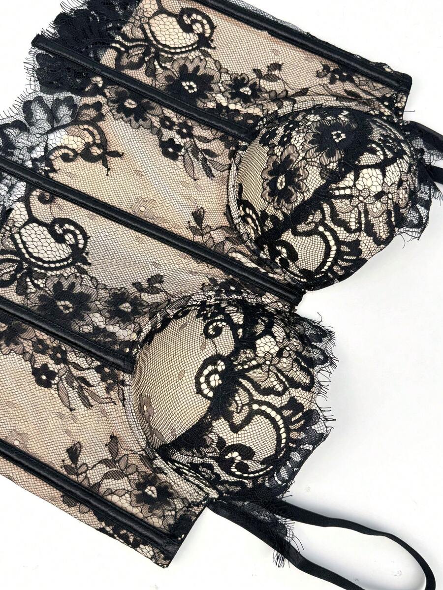 Black women's shaping cami with contrast lace, spaghetti straps, asymmetrical hem, lined body, and slim fit for casual and night-out styling.