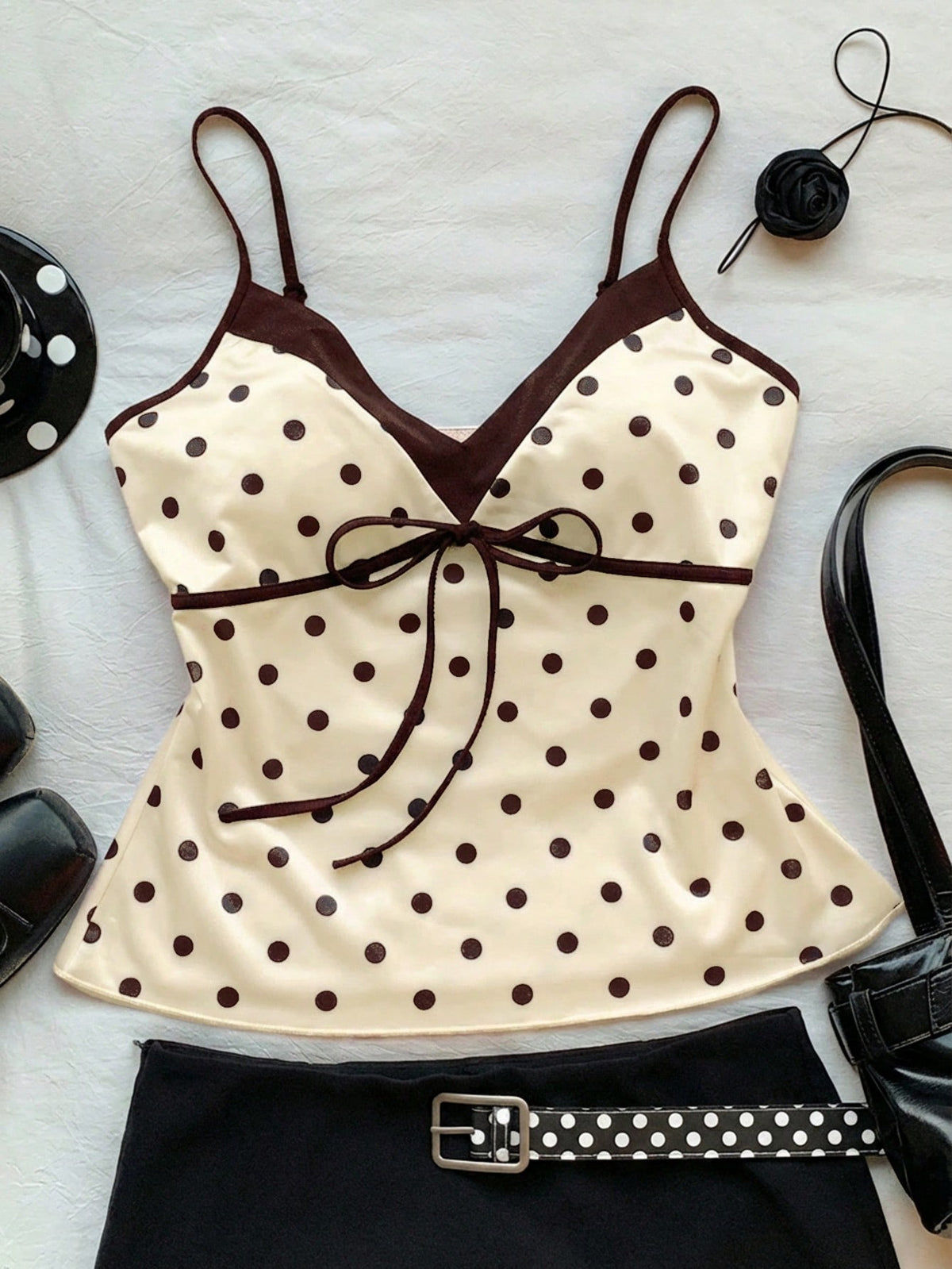 Black and white polka dot tie strap camisole top for women with thin spaghetti straps and slim fit.