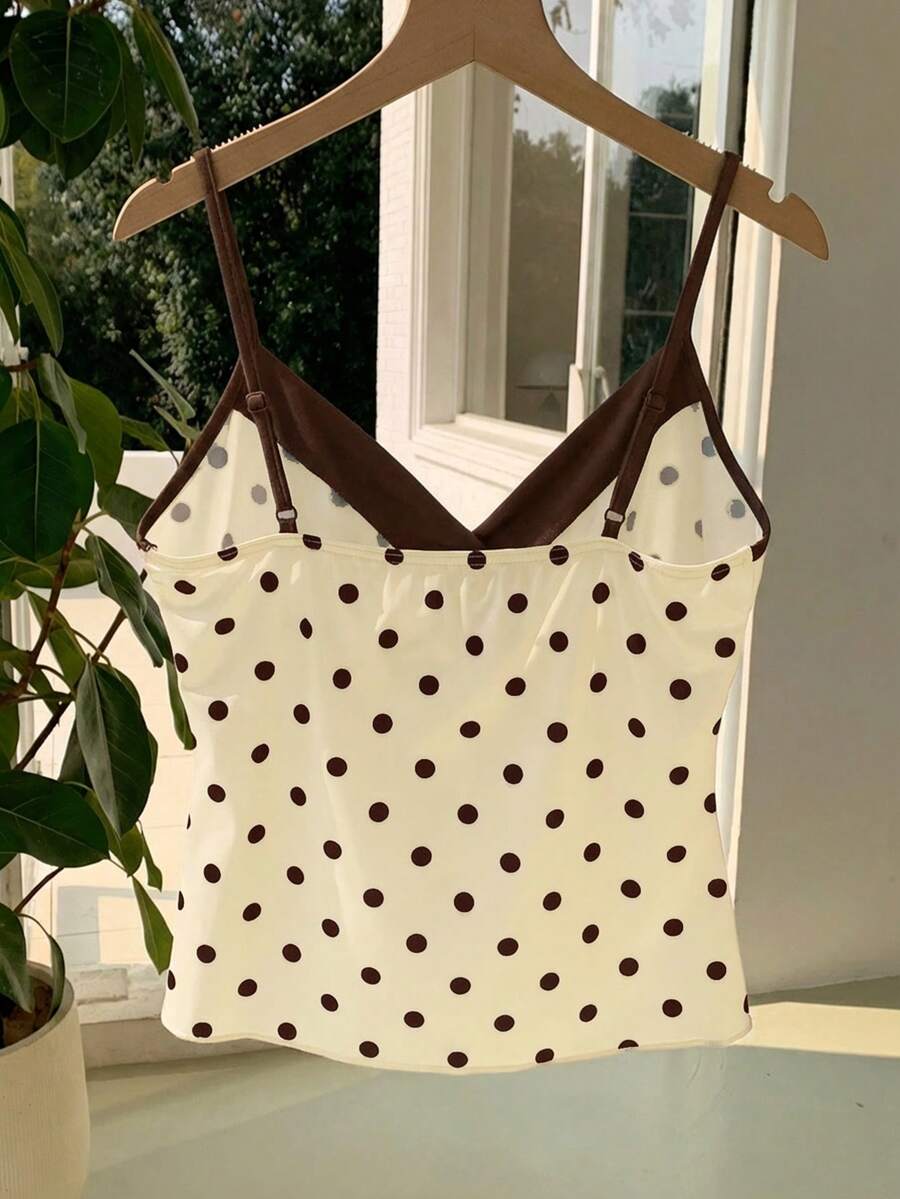 Black and white polka dot tie strap camisole top for women with thin spaghetti straps and slim fit.
