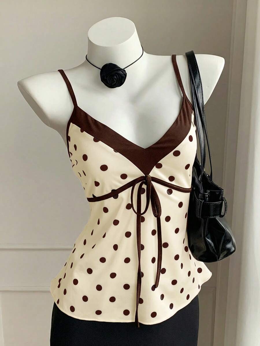 Black and white polka dot tie strap camisole top for women with thin spaghetti straps and slim fit.