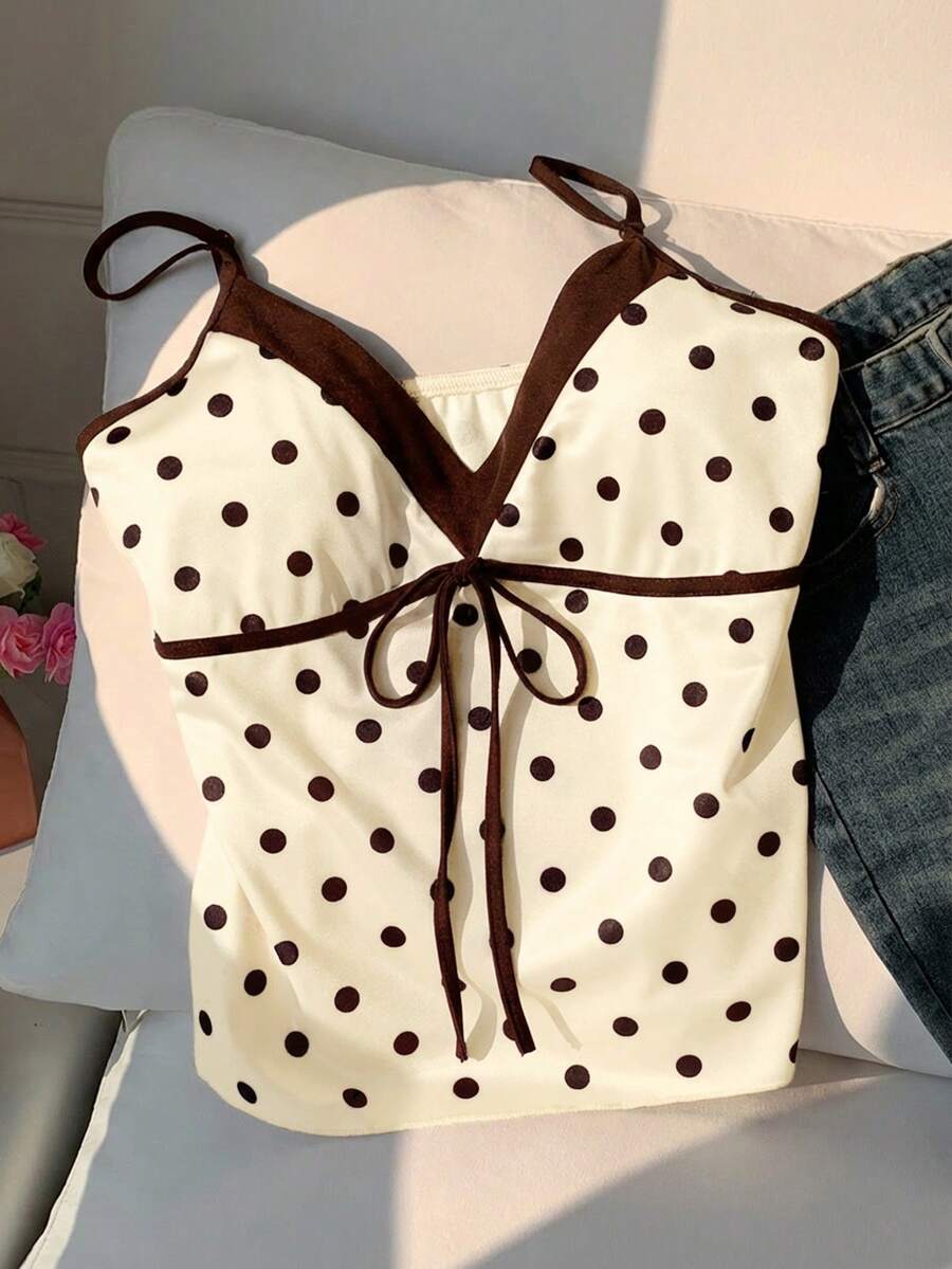 Black and white polka dot tie strap camisole top for women with thin spaghetti straps and slim fit.