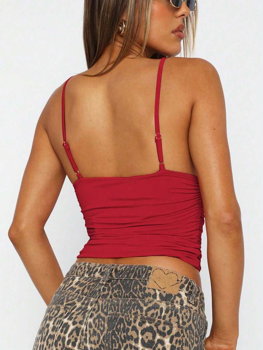 Women's V-neck backless camisole crop top with ruched detailing in a slim fit knit fabric.