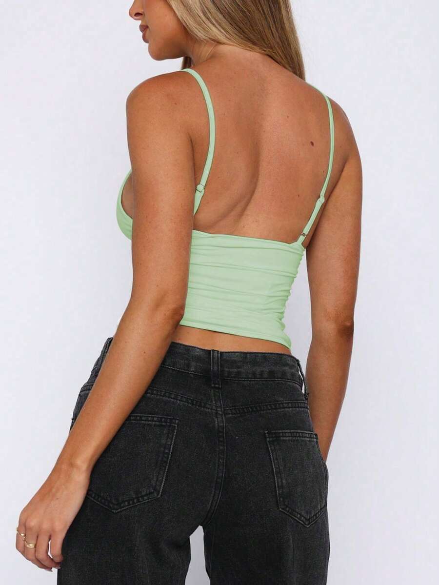 Women's V-neck backless camisole crop top with ruched detailing in a slim fit knit fabric.