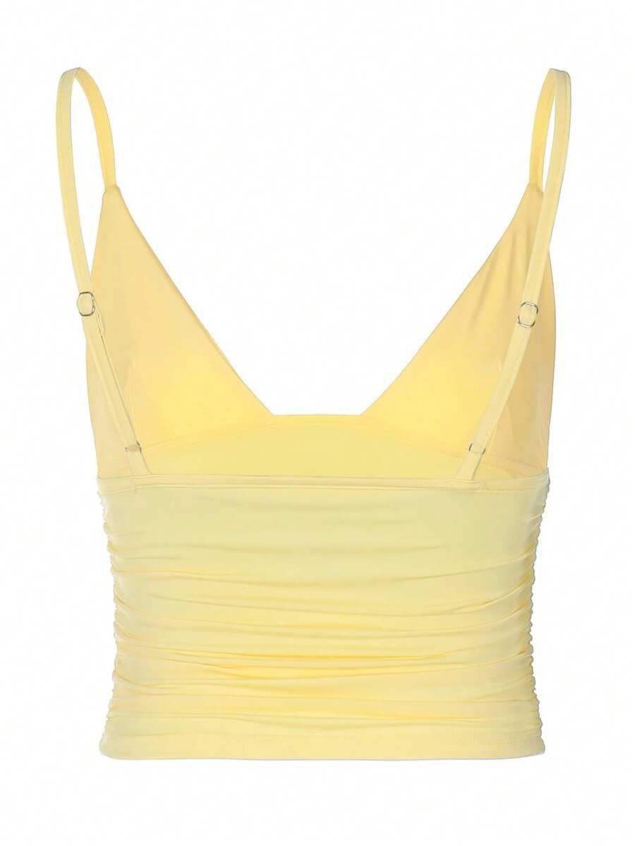 Women's V-neck backless camisole crop top with ruched detailing in a slim fit knit fabric.