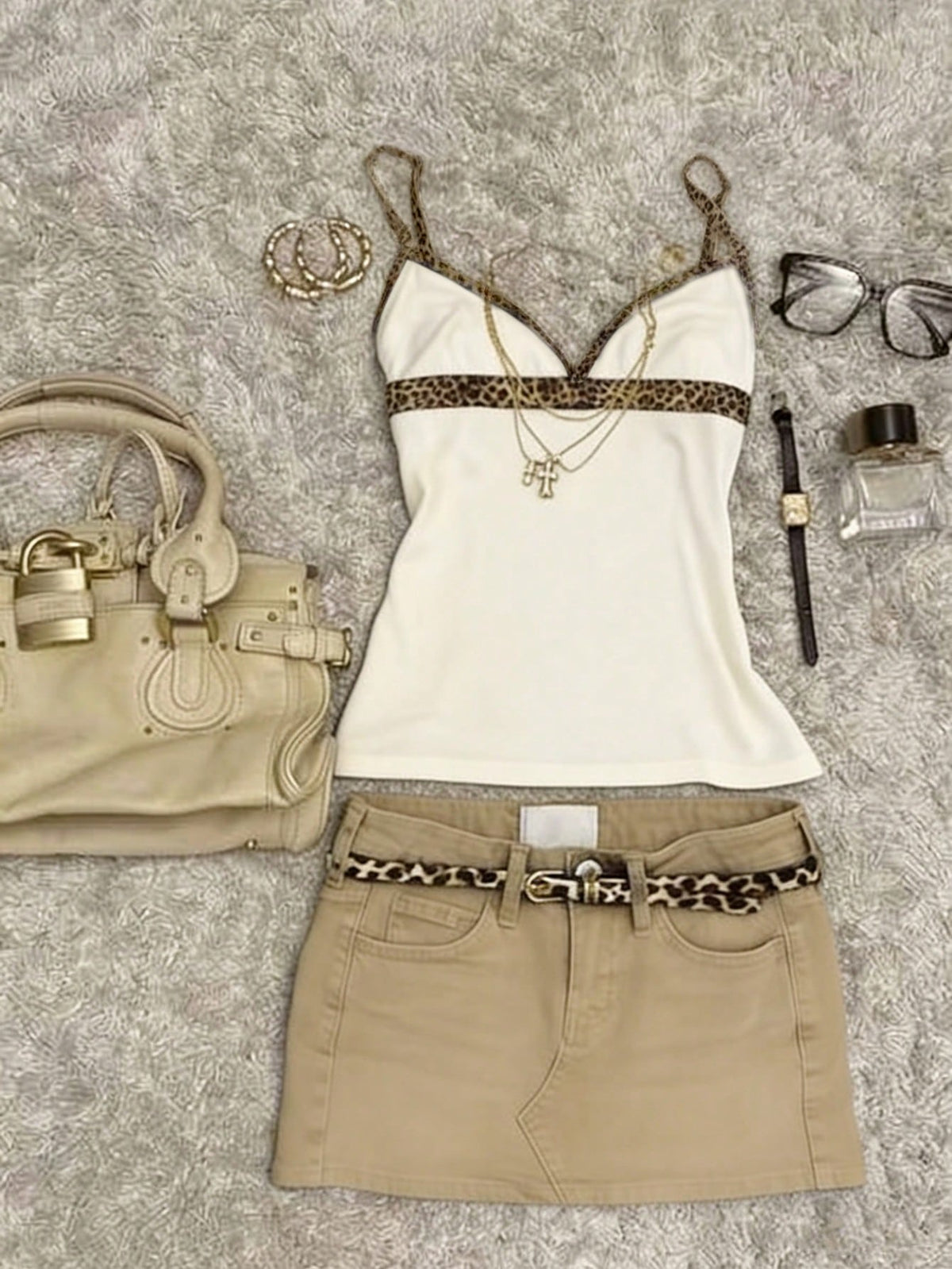 A women's solid slim fit camisole top with delicate contrast lace trim around the neckline and spaghetti straps.