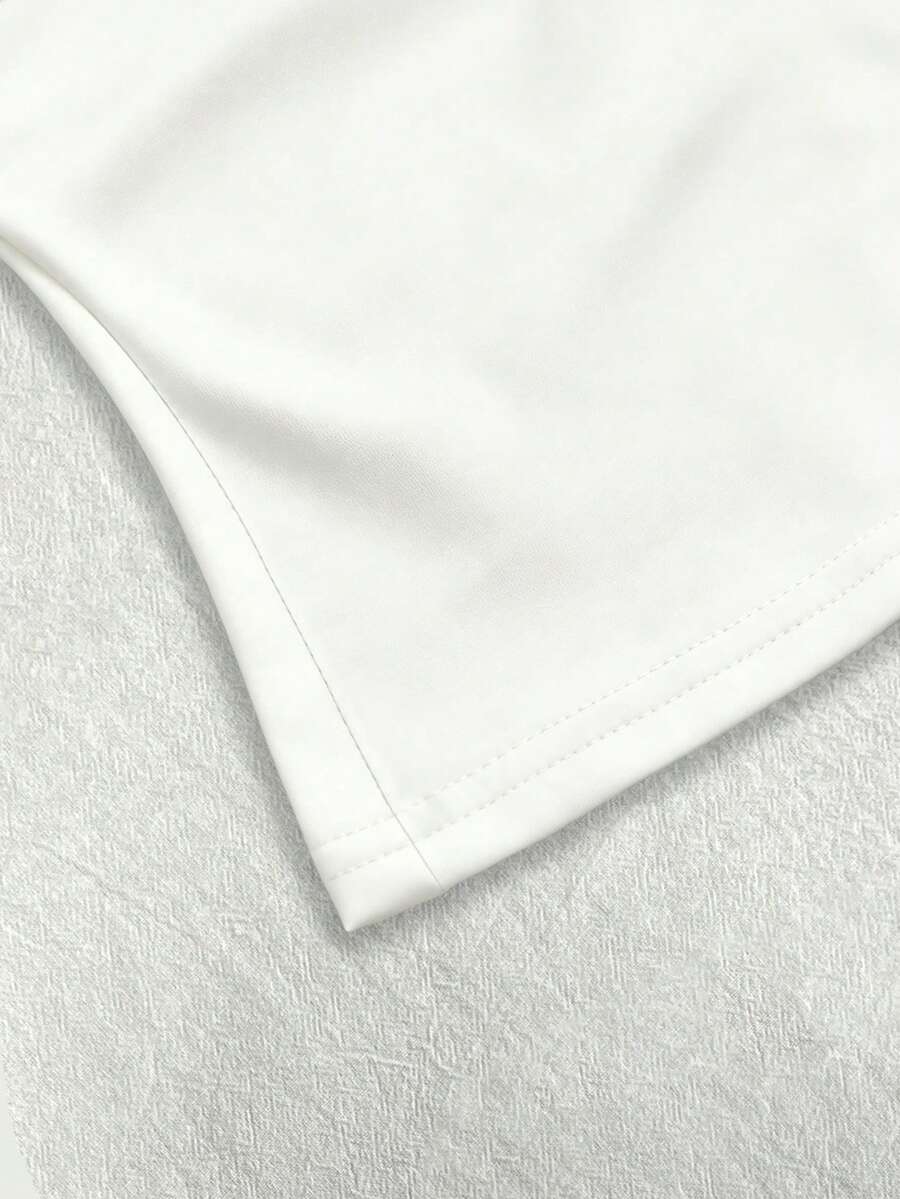 A women's solid slim fit camisole top with delicate contrast lace trim around the neckline and spaghetti straps.