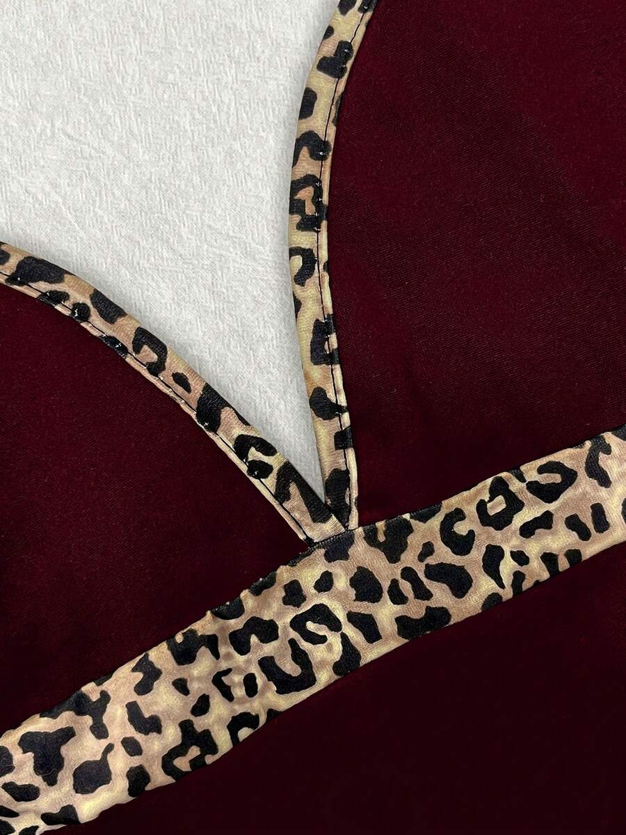 A women's solid slim fit camisole top with delicate contrast lace trim around the neckline and spaghetti straps.