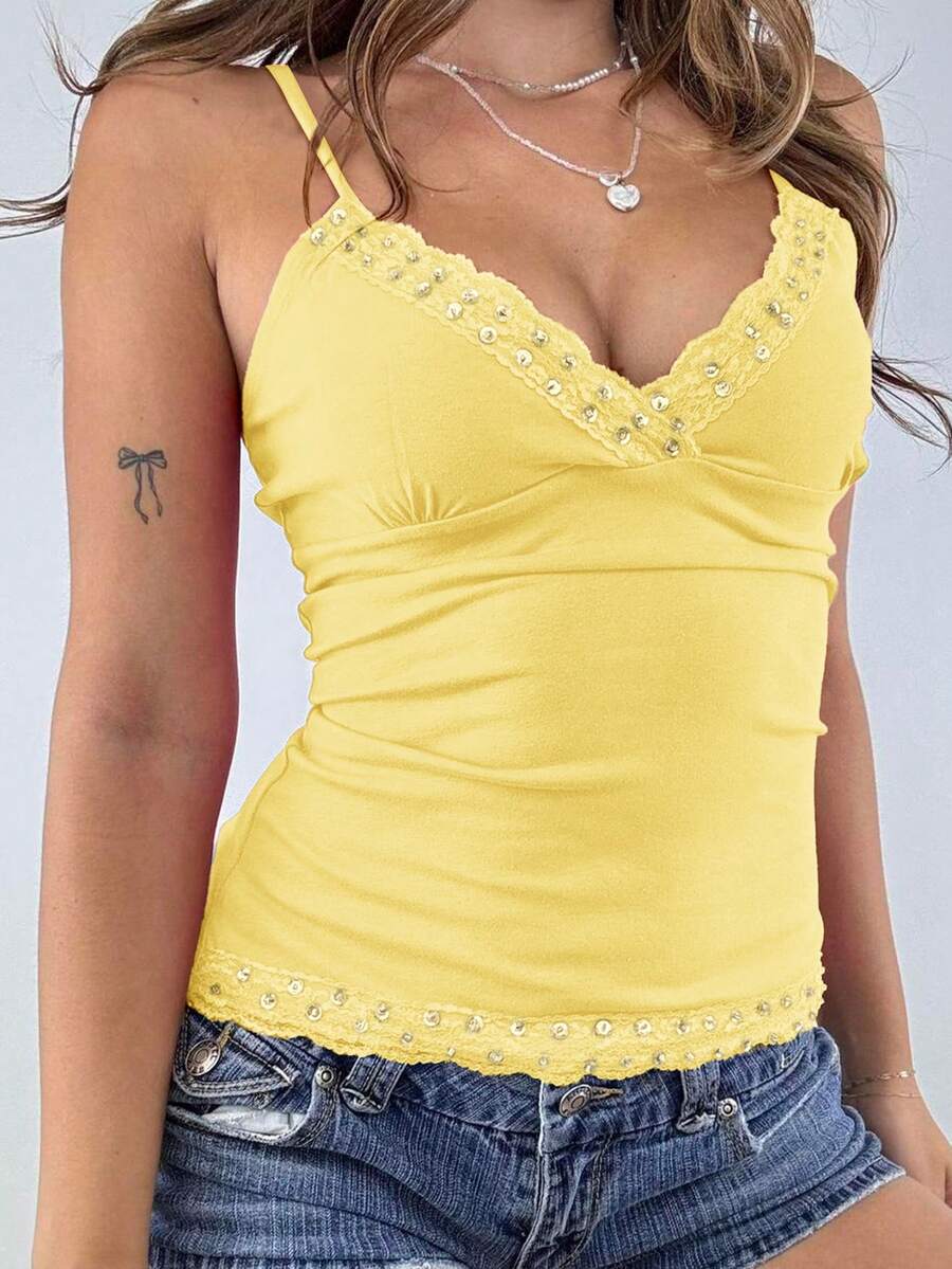 Women's deep V-neck camisole top featuring contrast hollow lace trim, cutout detail, and thin spaghetti straps.