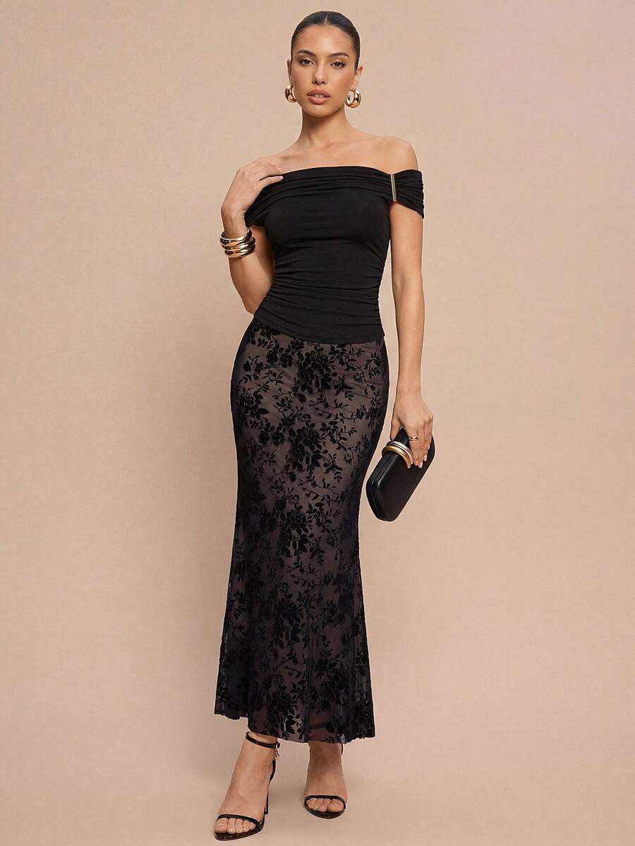 Women's black lace long mermaid skirt featuring lettuce trim, ruffle hem, random print pattern, low waist, and zipper detail.