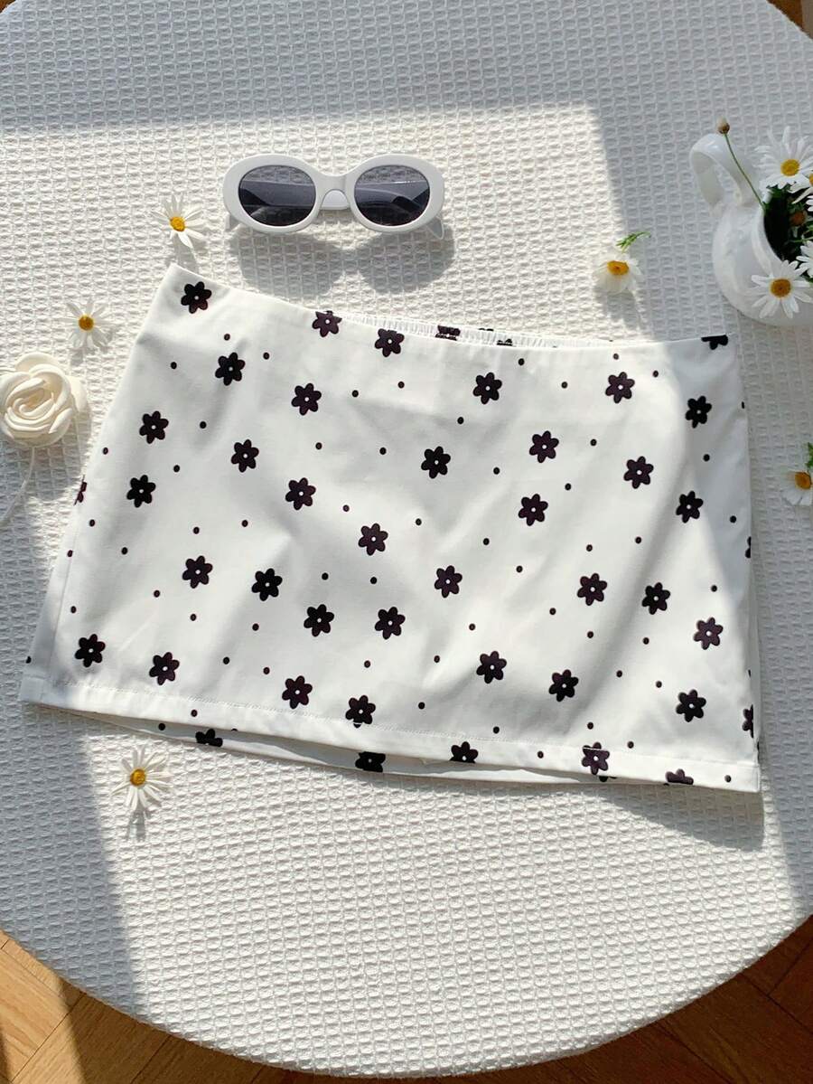 Women's white 100% cotton low waist mini skirt featuring a tropical print and zipper detail.