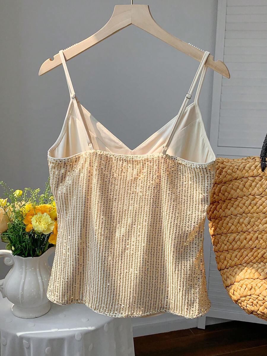 Black and white polka dot tie strap camisole top for women with thin spaghetti straps and slim fit.