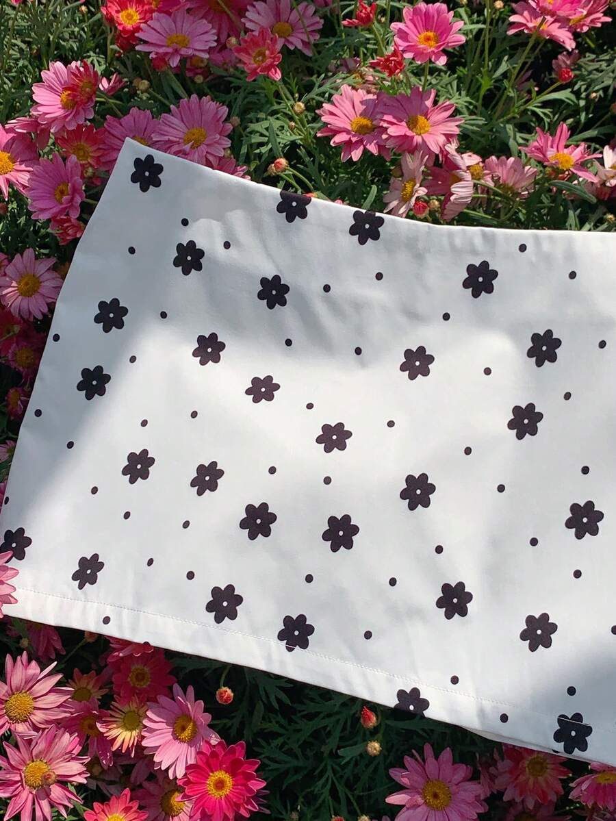 Women's white 100% cotton low waist mini skirt featuring a tropical print and zipper detail.