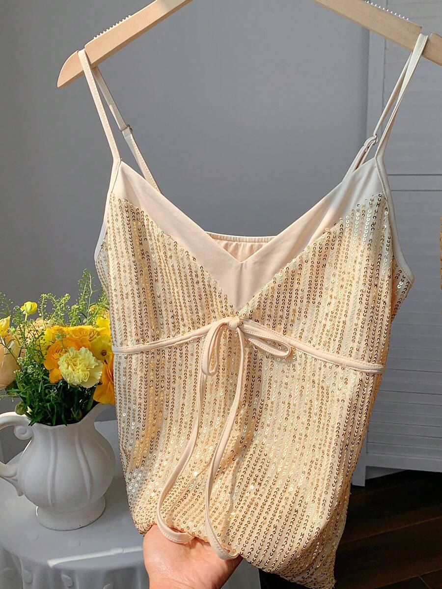 Black and white polka dot tie strap camisole top for women with thin spaghetti straps and slim fit.