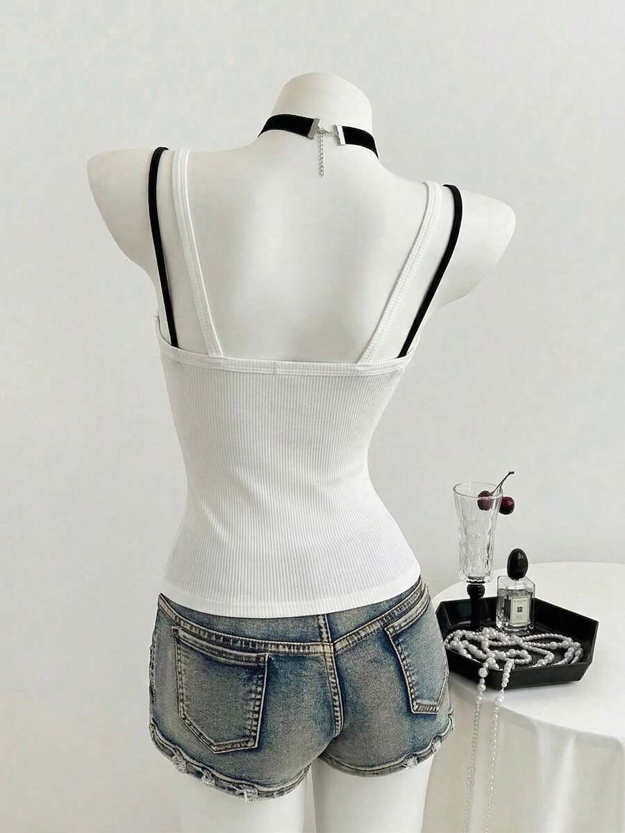 Women's slim fit spaghetti strap cami tank top with contrast lace trim along the neckline