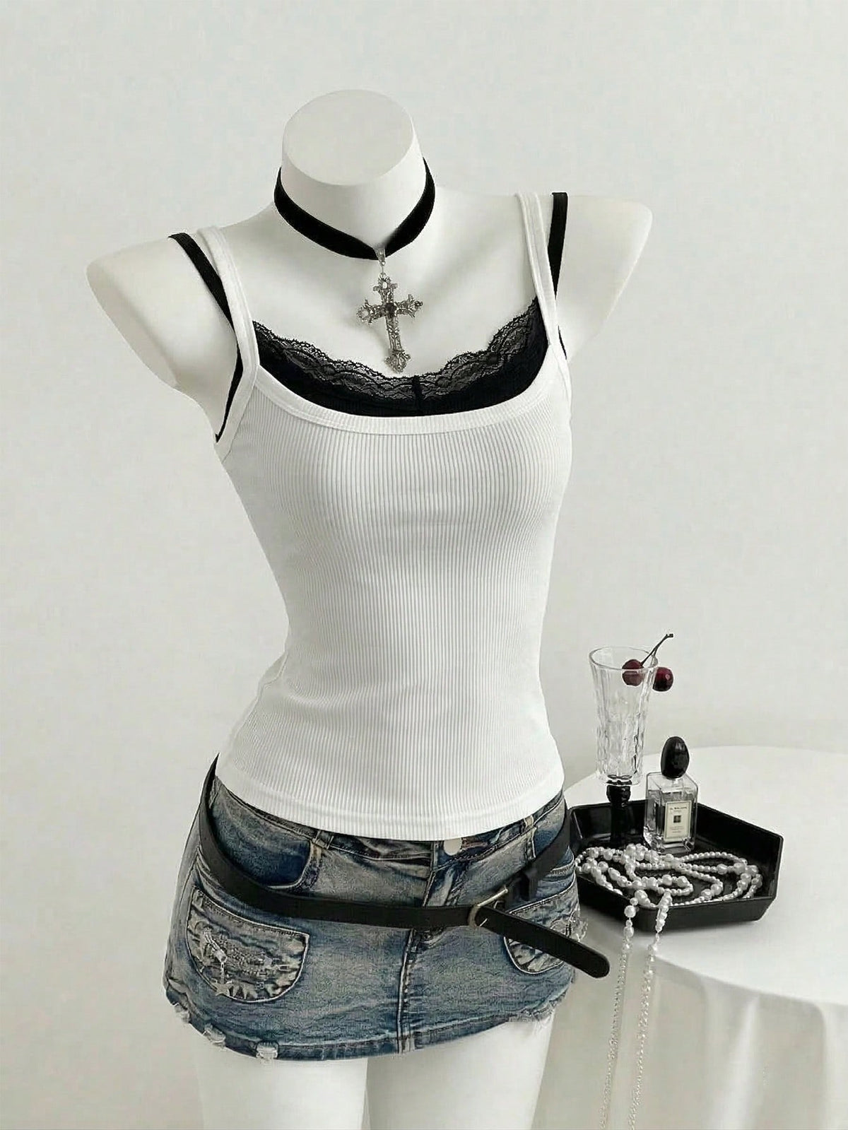 Women's slim fit spaghetti strap cami tank top with contrast lace trim along the neckline